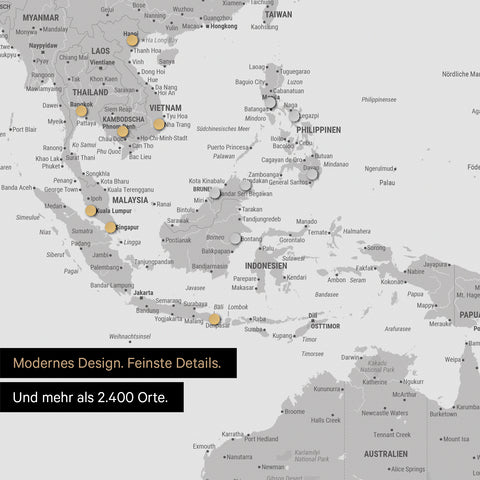Ausschnitt einer magnetischen Weltkarte in Hellgrau zeigt Karte von Asien, auf der Magnete Reiseziele markieren