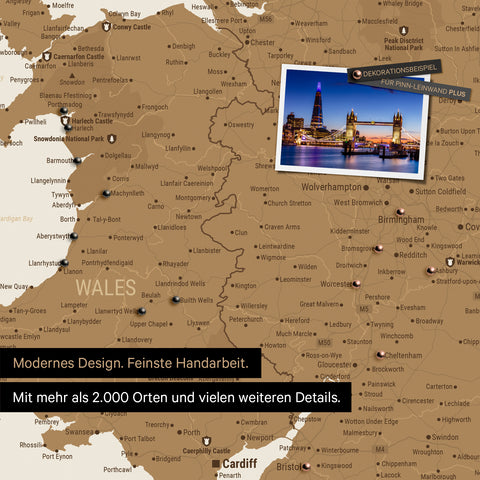 Section of a map of Wales and England in bronze with pins to mark visited destinations