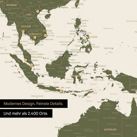 Ausschnitt einer magnetischen Weltkarte in Olive Green zeigt Karte von Asien, auf der Magnete Reiseziele markieren